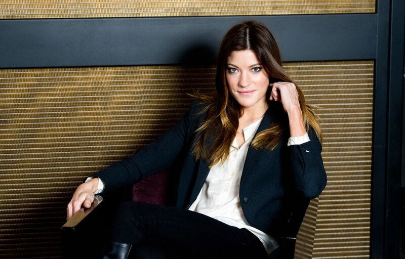 woman in black blazer sitting