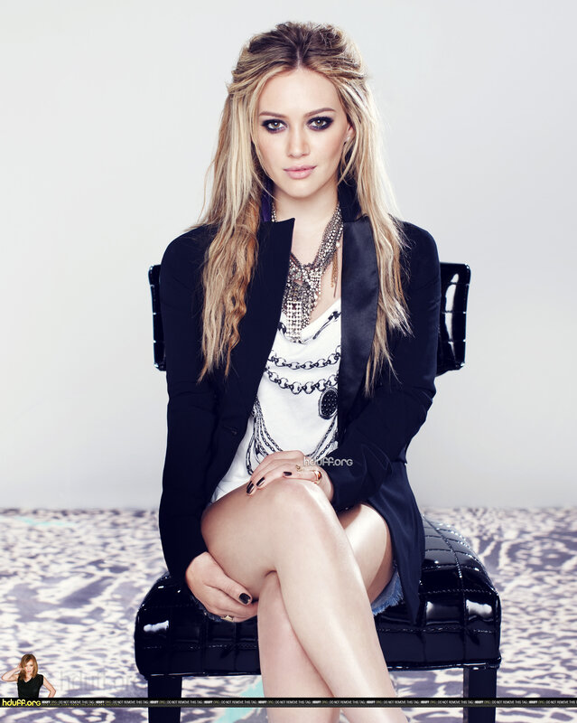woman in black blazer sitting