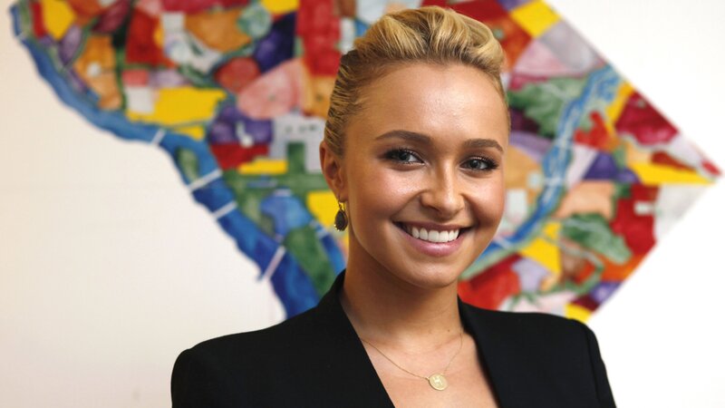 woman in black blazer smiling