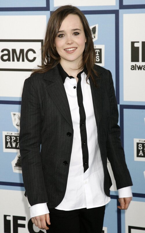 woman in black blazer smiling