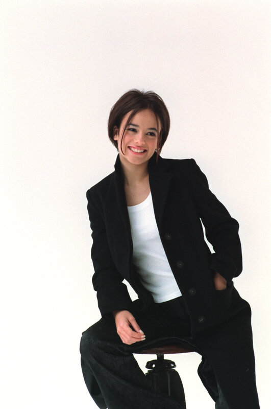 woman in black blazer smiling