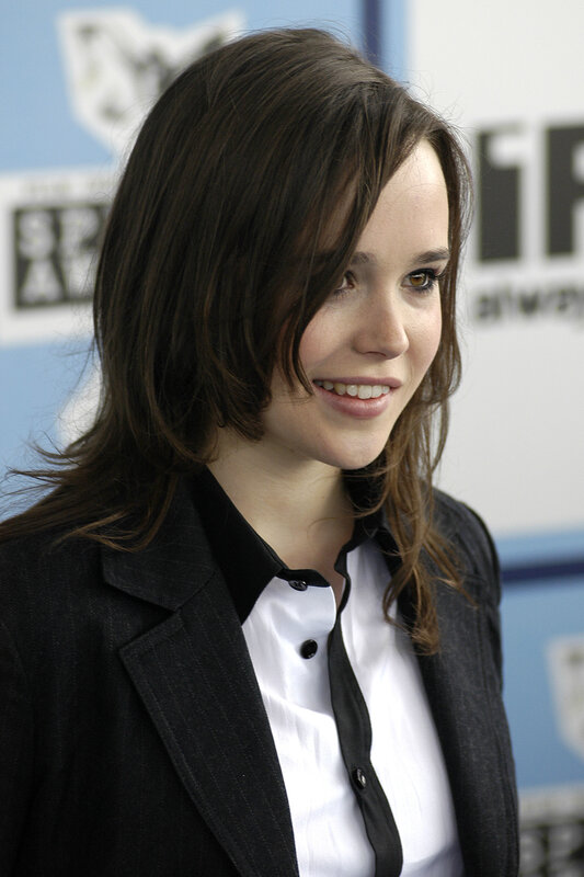 woman in black blazer smiling