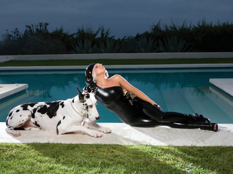 Woman in black bodysuit by pool