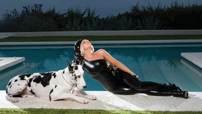 Woman in black bodysuit by pool