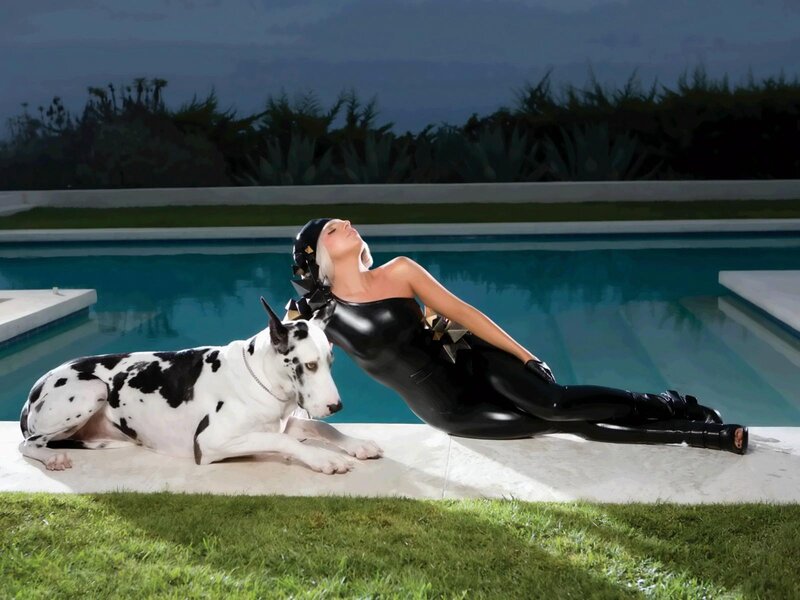 Woman in black bodysuit by pool