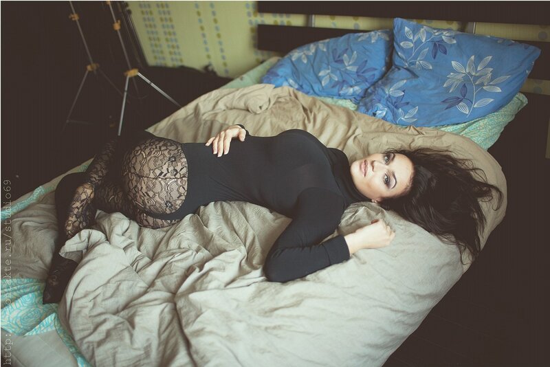woman in black bodysuit on bed