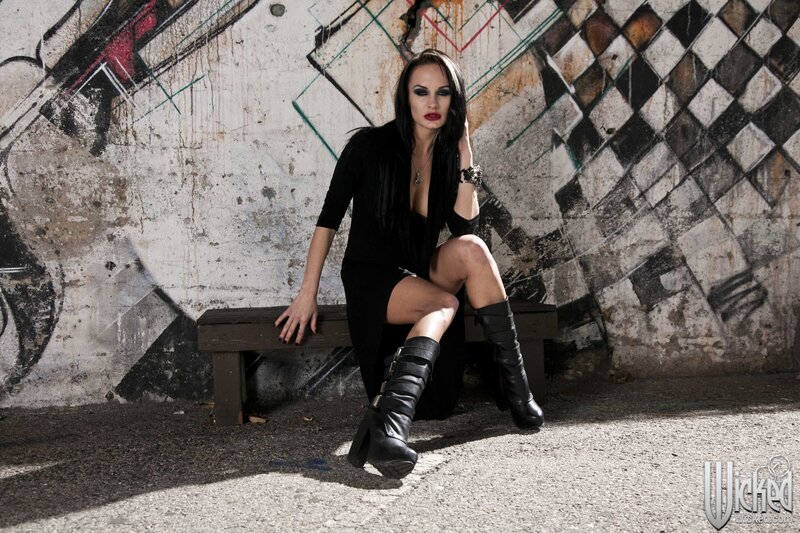 woman in black boots on bench