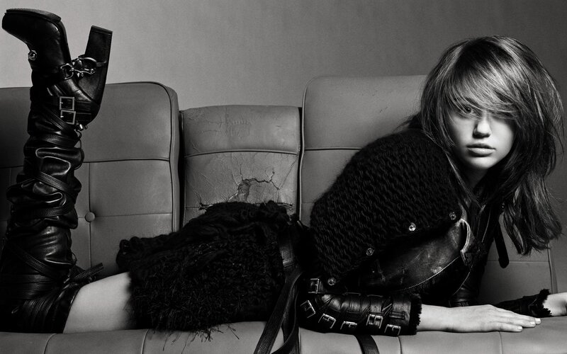 woman in black boots on couch