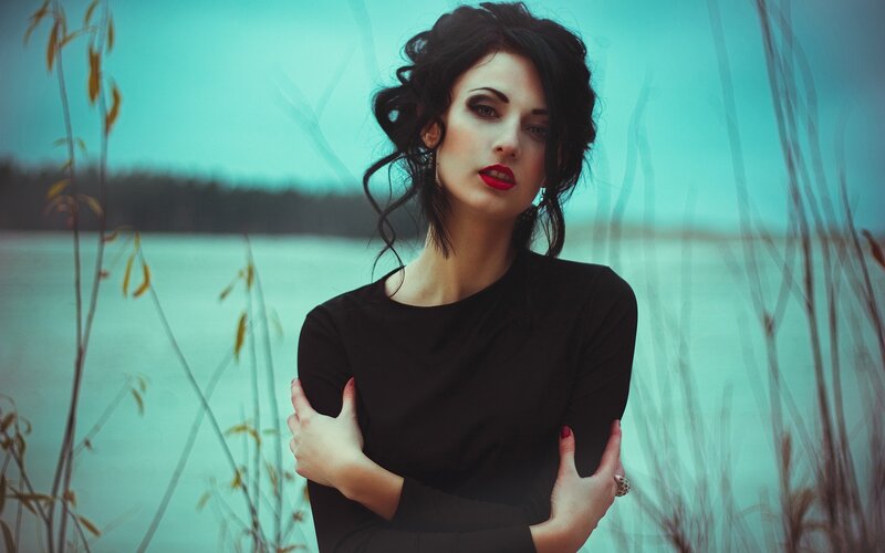 woman in black by the water