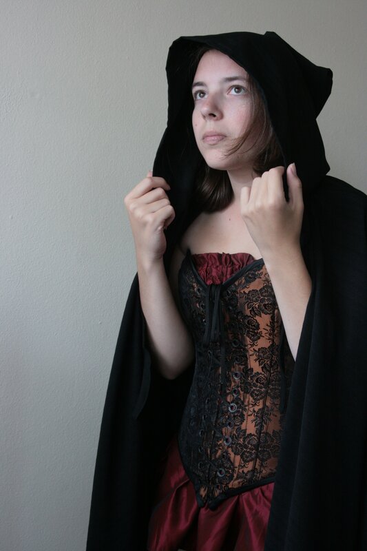 woman in black cloak
