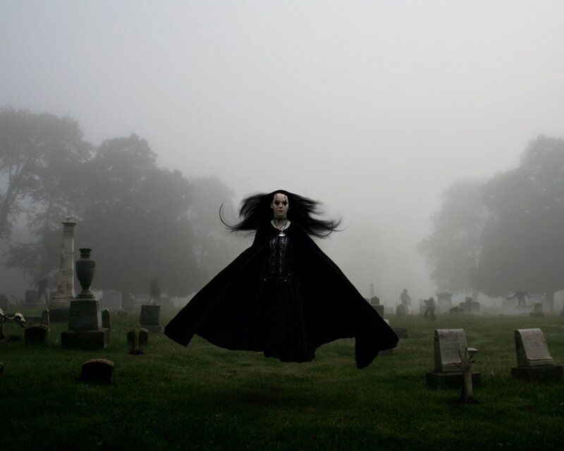 woman in black cloak floating