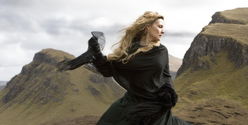 Woman in black cloak on a mountain
