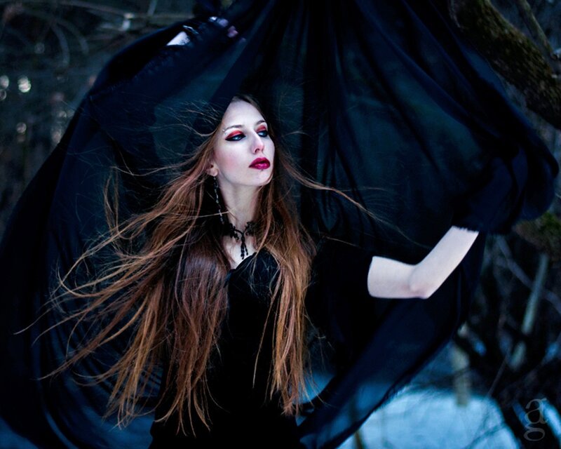 woman in black cloak with red makeup