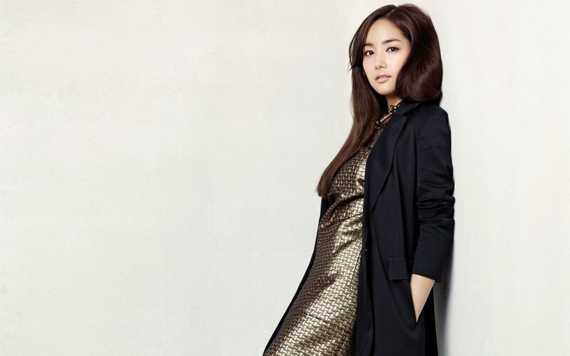 woman in black coat and gold dress