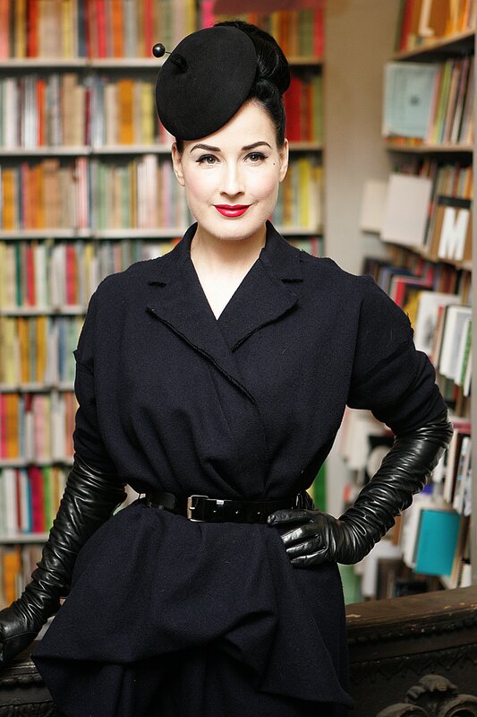 Woman in black coat and hat