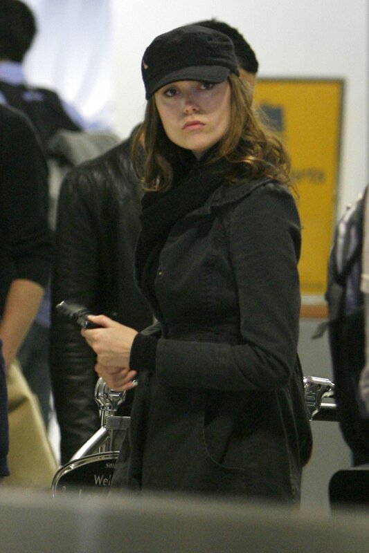 woman in black coat at airport