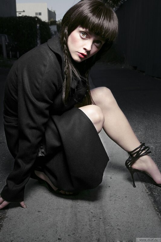 woman in black coat crouching