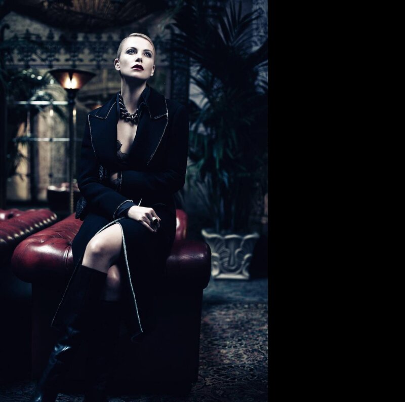 Woman in Black Coat — Dramatic, Night, Photograph, Red Leather Couch