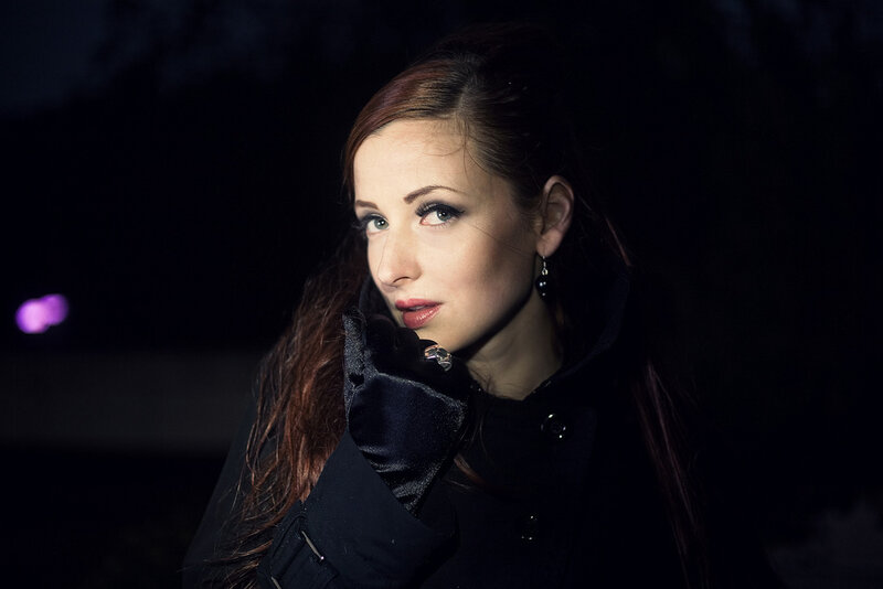Woman in Black Coat — Dramatic, Night, Photograph