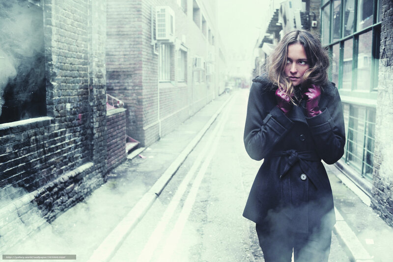 Woman in Black Coat — Dramatic, Winter, Photograph, Brick Buildings