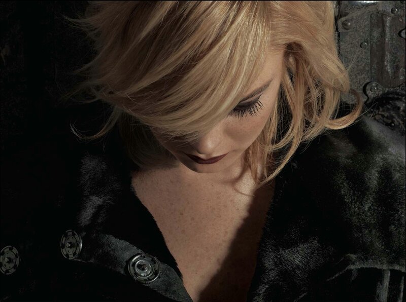 woman in black coat looking down