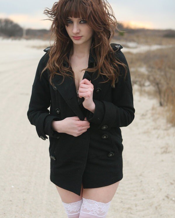 woman in black coat on beach