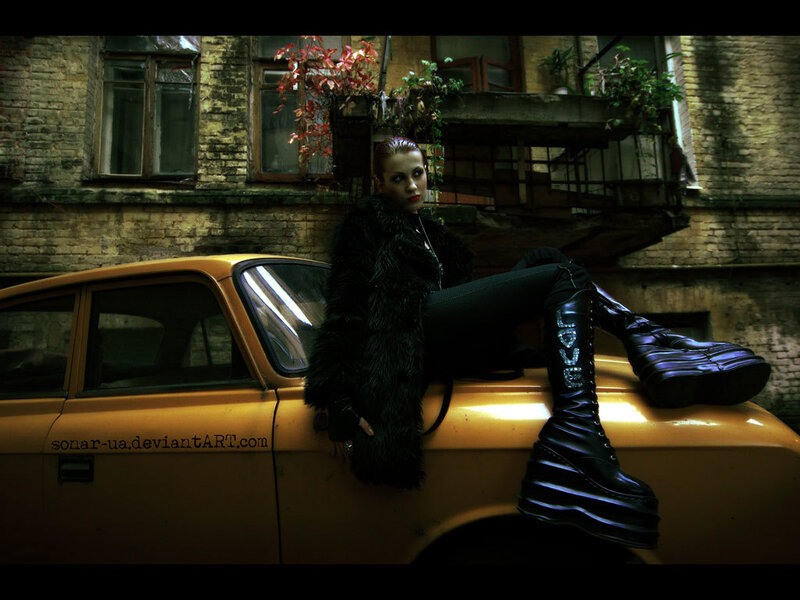 woman in black coat on car