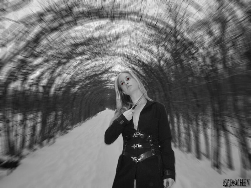 woman in black coat on snowy path