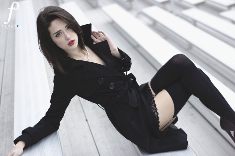 woman in black coat sitting on steps