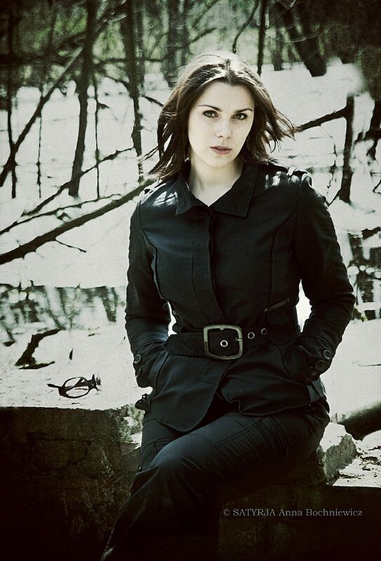 woman in black coat sitting outdoors