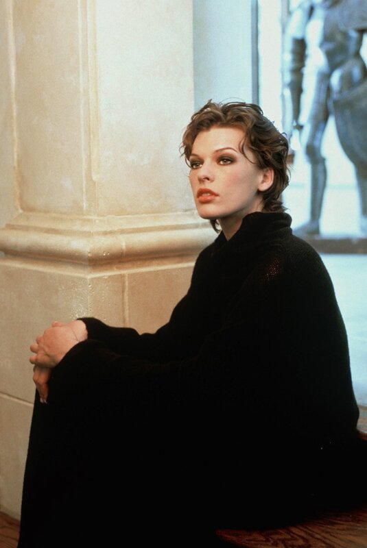woman in black coat sitting
