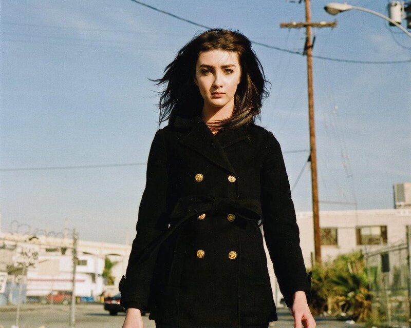 woman in black coat walking