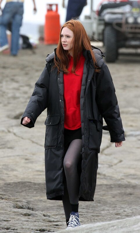 woman in black coat walking