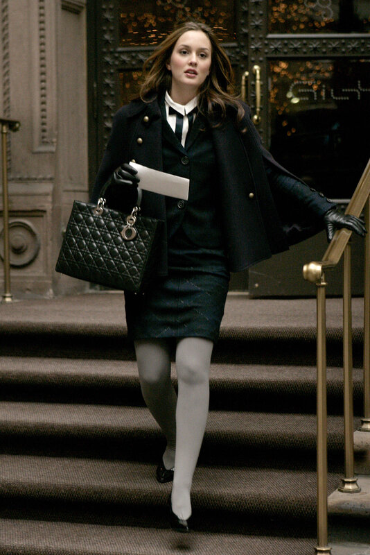 woman in black coat walking down stairs