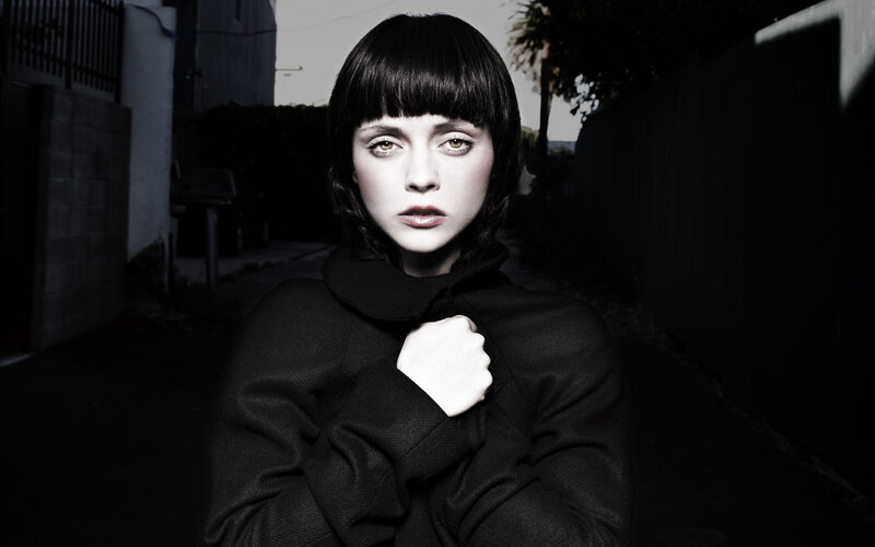 woman in black coat with bangs
