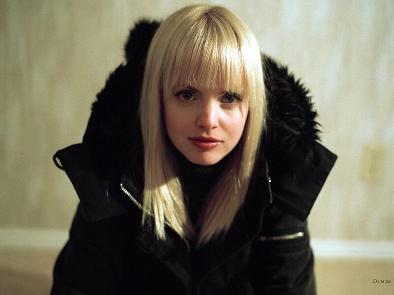 woman in black coat with blonde hair