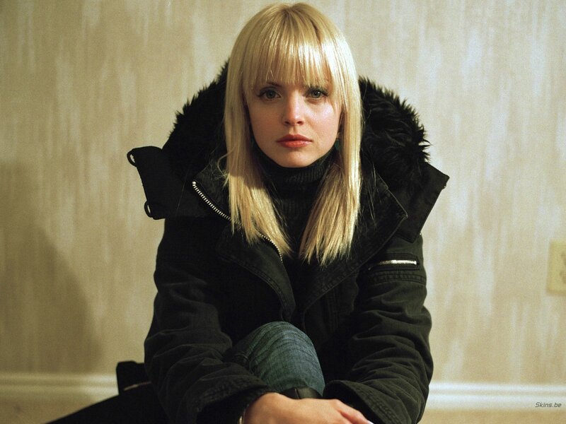 Woman in black coat with blonde hair