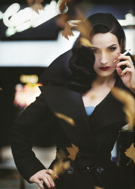 woman in black coat with cigarette