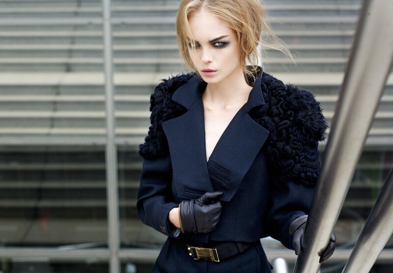 woman in black coat with dramatic makeup
