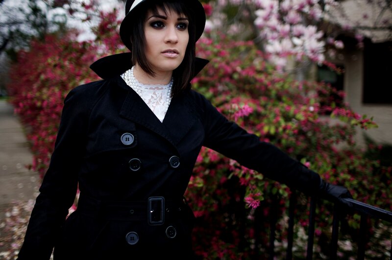 woman in black coat with flowers