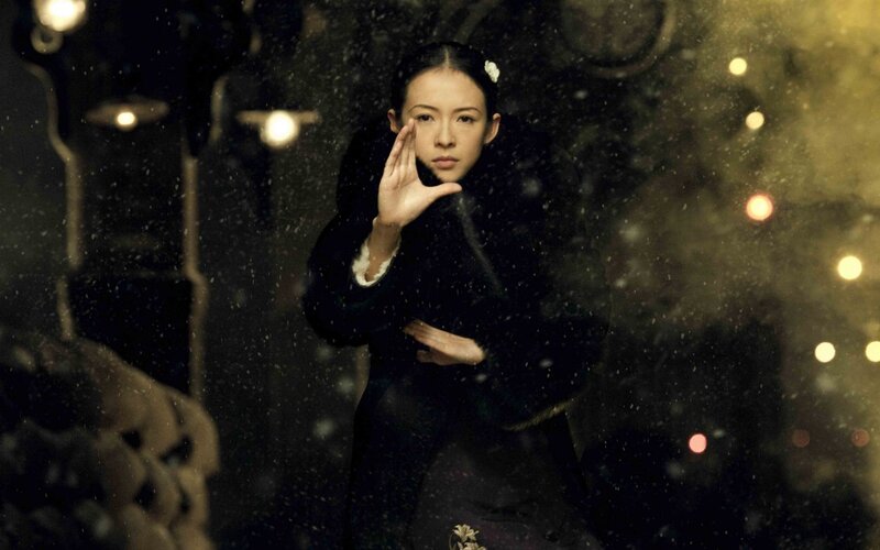 woman in black coat with hand gesture