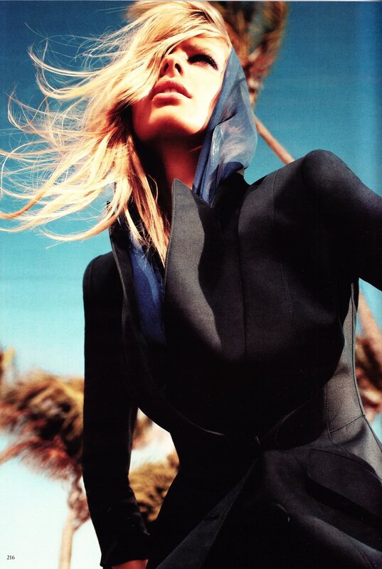 woman in black coat with wind-blown hair
