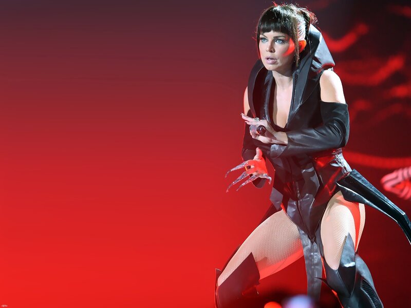 woman in black costume on stage
