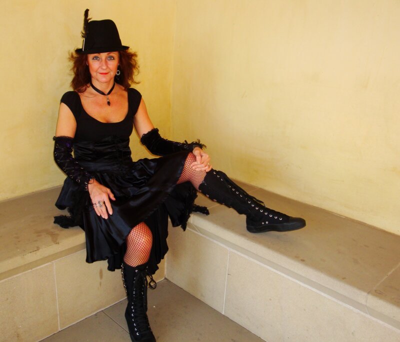Woman in black costume sitting