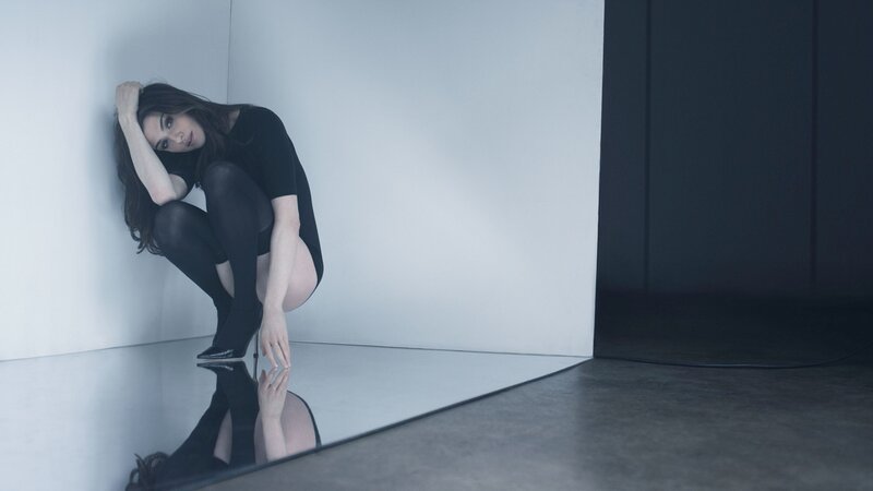 woman in black crouching