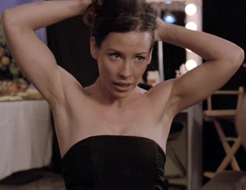 woman in black dress adjusting hair