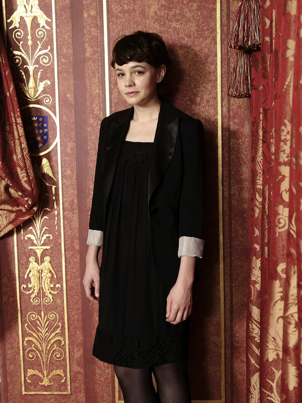 woman in black dress against ornate wall