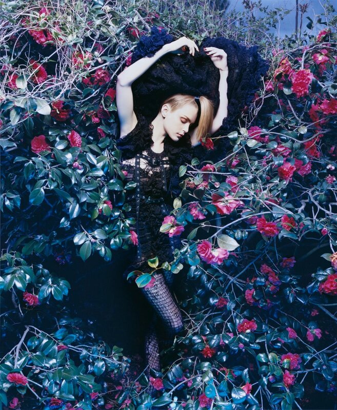 woman in black dress among flowers