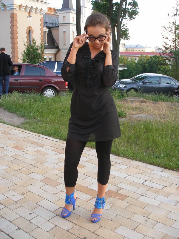 Woman in black dress and blue heels