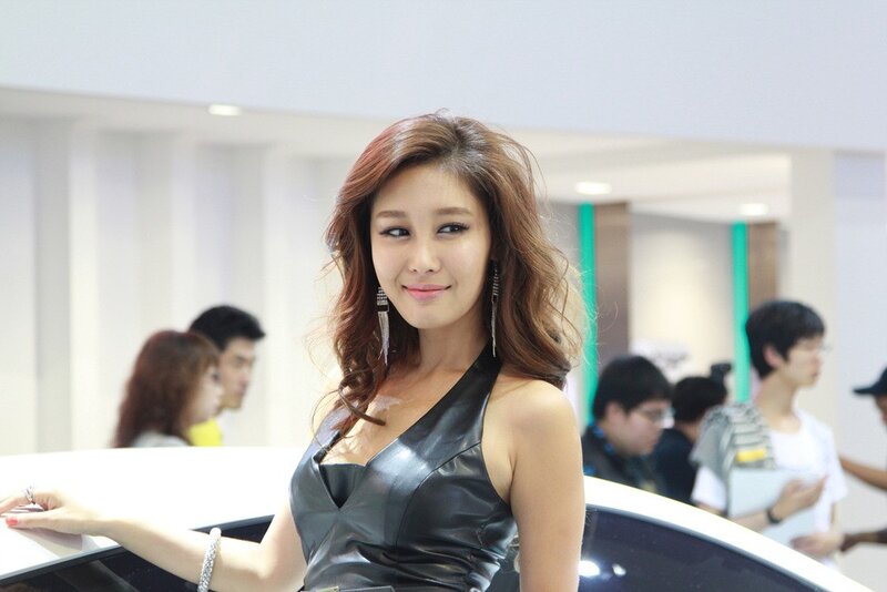 Woman in black dress at auto show